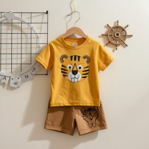 Toddler boys' camel brown pocket t-shirt and cream bison print shorts set flat lay.